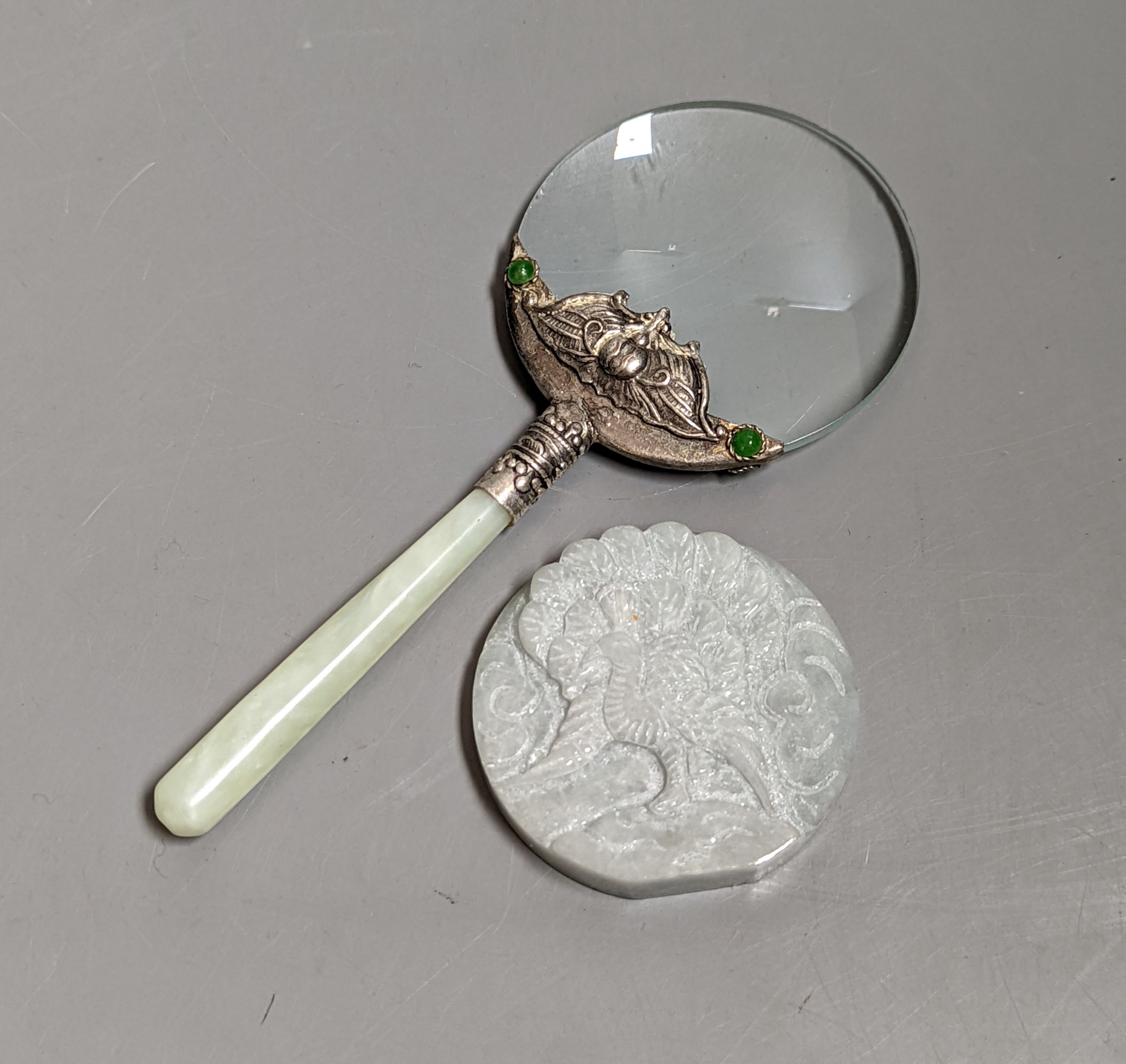 A Chinese bowenite jade handled magnifying glass, (14 cms long) and a jadeite peacock plaque